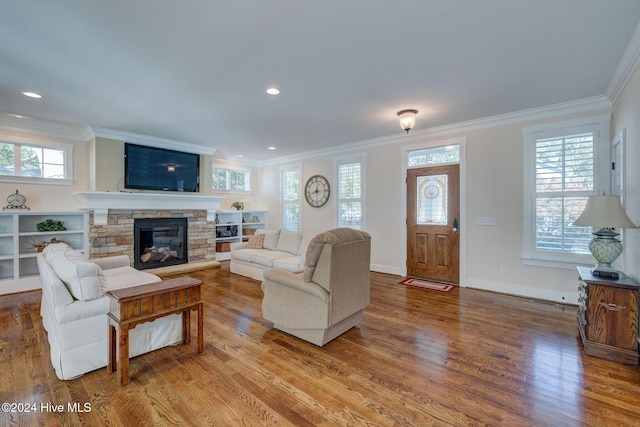 living room featuring crown molding, a fireplace, and hardwood / wood-style flooring