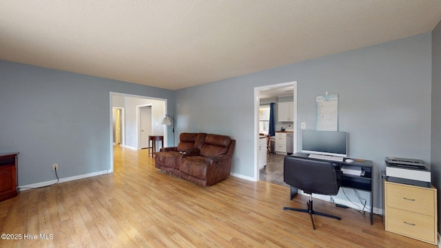 home office with light wood finished floors and baseboards