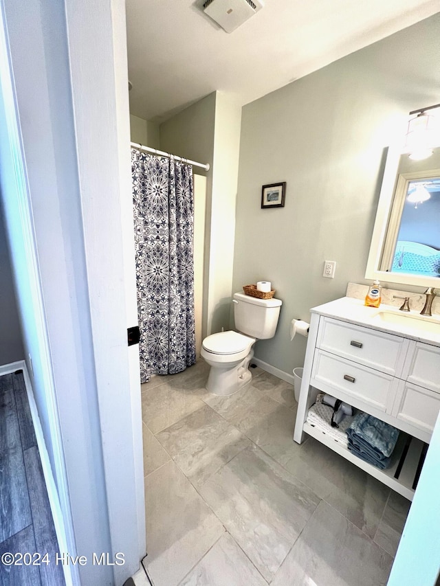 bathroom featuring vanity and toilet