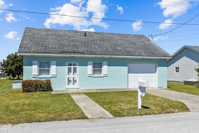 view of front of house with a front lawn and a garage