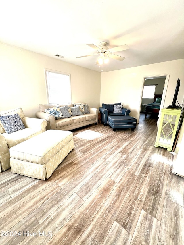 living room with ceiling fan and hardwood / wood-style floors