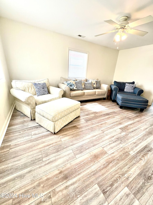 living room with ceiling fan and hardwood / wood-style flooring