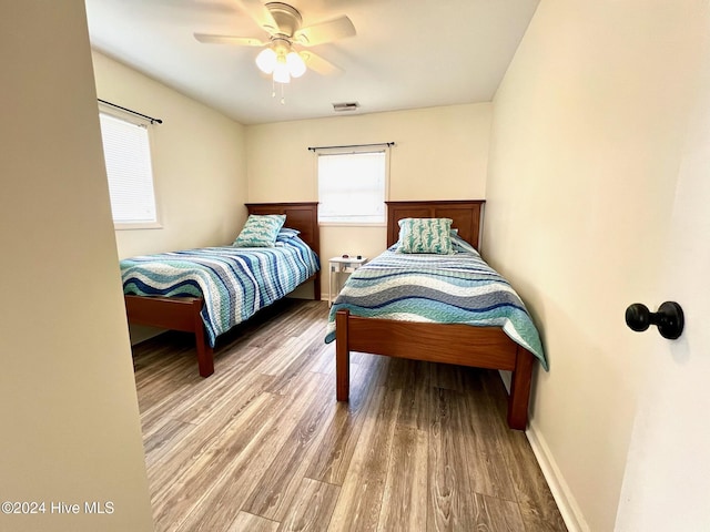 bedroom with ceiling fan and hardwood / wood-style flooring