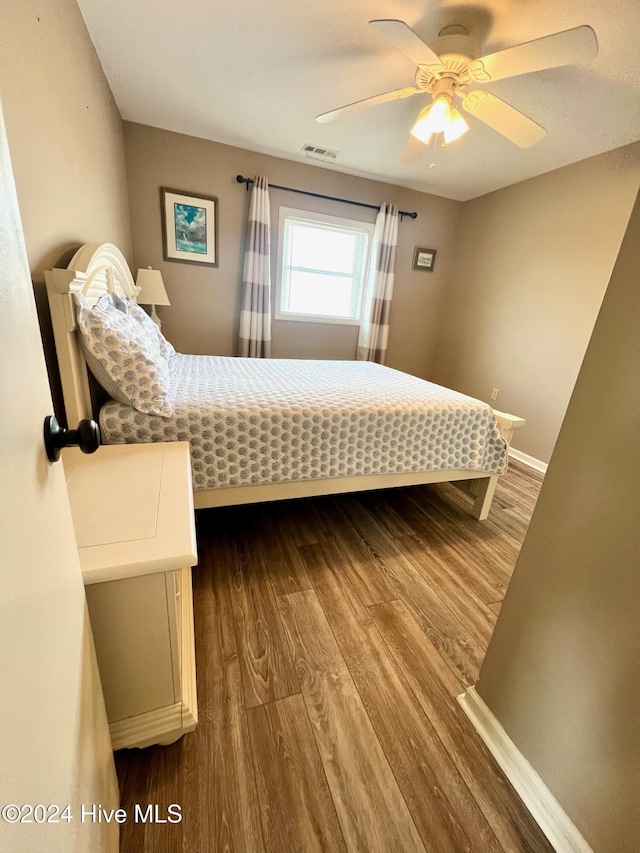 bedroom with ceiling fan and wood-type flooring