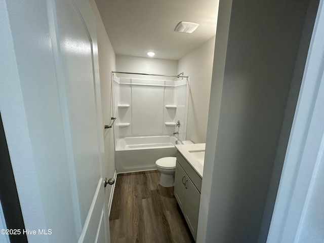 full bathroom with vanity, bathing tub / shower combination, wood finished floors, and toilet