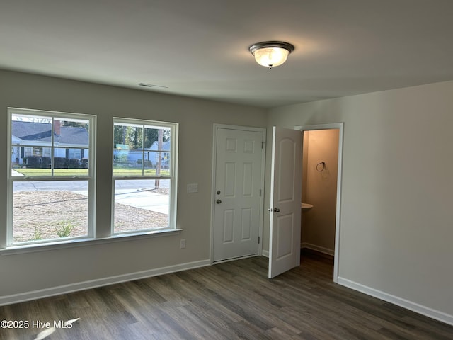 entryway with visible vents, dark wood finished floors, and baseboards