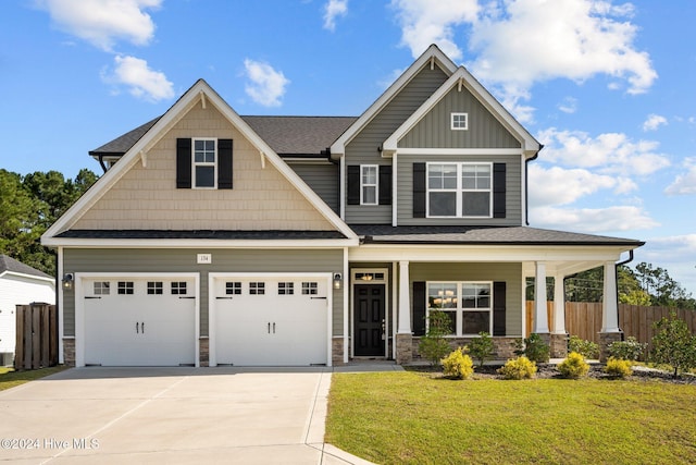 craftsman house with a porch, a garage, and a front yard