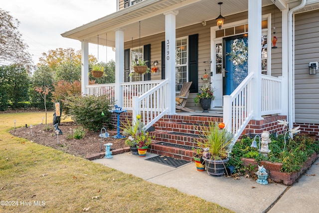 view of exterior entry featuring a porch