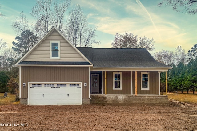 view of front facade featuring a porch and a garage