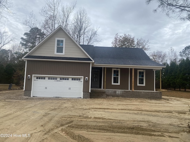 view of front of home with a porch and a garage