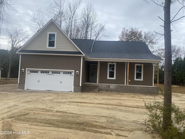 view of front facade featuring a porch and a garage