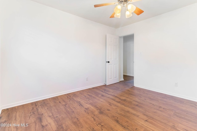 unfurnished room featuring dark hardwood / wood-style floors and ceiling fan