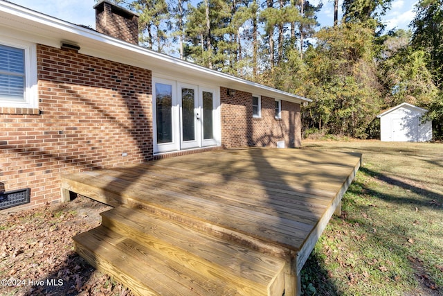 wooden deck featuring french doors and a shed