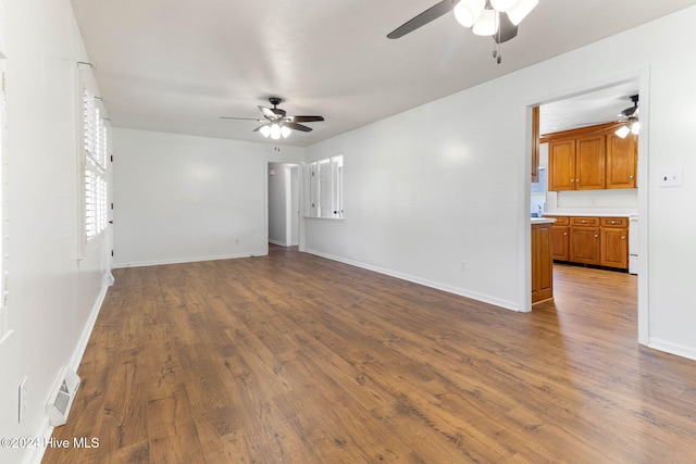 unfurnished living room featuring ceiling fan and wood-type flooring