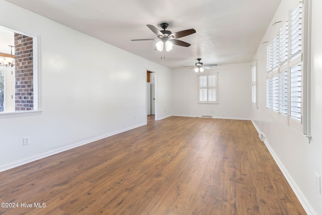 unfurnished room featuring ceiling fan and dark hardwood / wood-style flooring