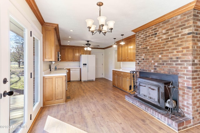 kitchen with light hardwood / wood-style floors, white appliances, hanging light fixtures, and ornamental molding