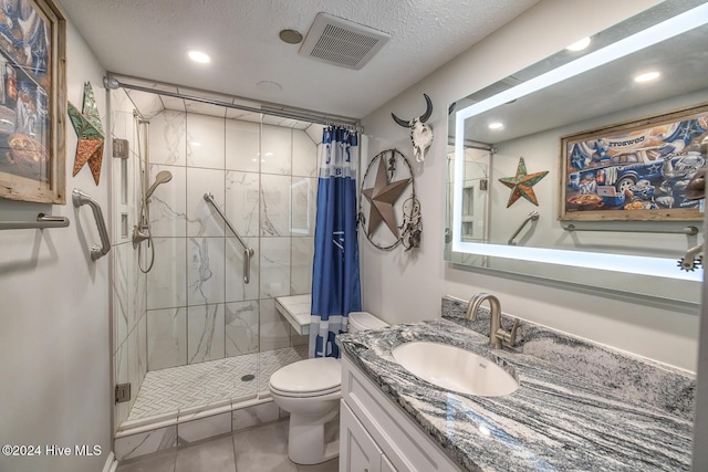 bathroom with a shower with curtain, tile patterned flooring, vanity, and toilet