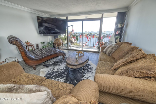 living room featuring a textured ceiling, hardwood / wood-style flooring, floor to ceiling windows, and crown molding