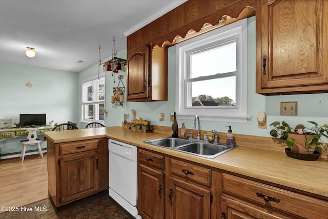 kitchen featuring kitchen peninsula, dark wood-type flooring, white dishwasher, a textured ceiling, and sink