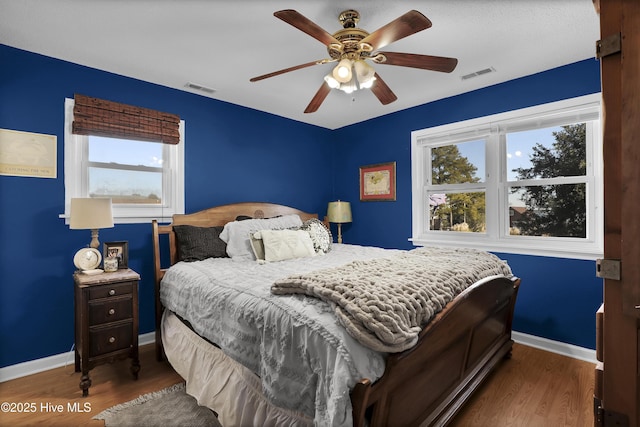 bedroom featuring ceiling fan and dark hardwood / wood-style flooring