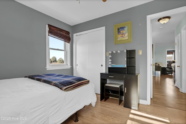 bedroom with a closet and light hardwood / wood-style floors