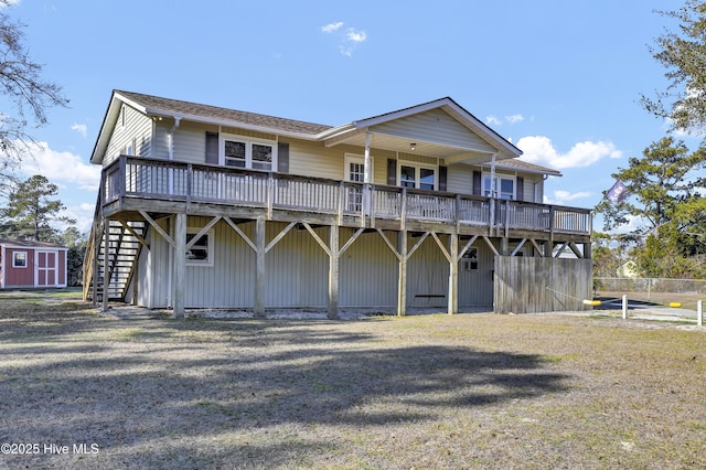 view of front of home featuring a wooden deck and a front yard