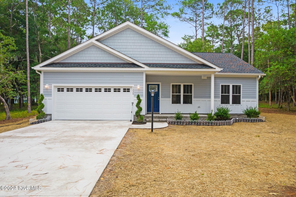 view of front facade with covered porch and a garage