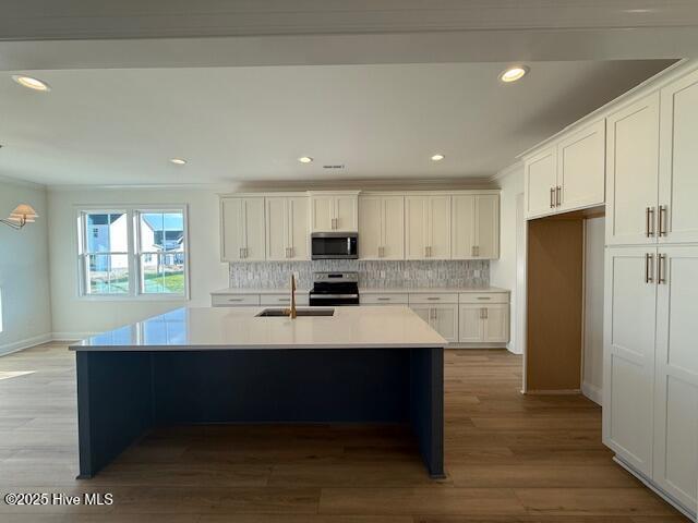 kitchen featuring white cabinetry and crown molding