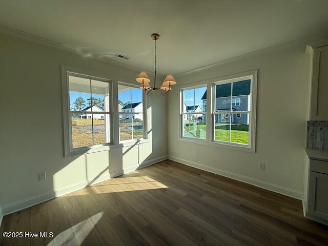 unfurnished living room featuring crown molding