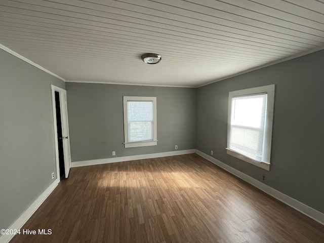 empty room featuring crown molding, hardwood / wood-style floors, and wood ceiling