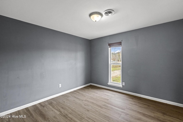 empty room with hardwood / wood-style flooring