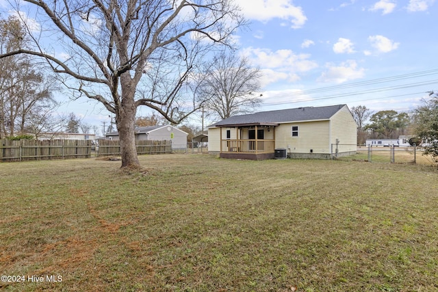 view of yard with central AC unit and a deck