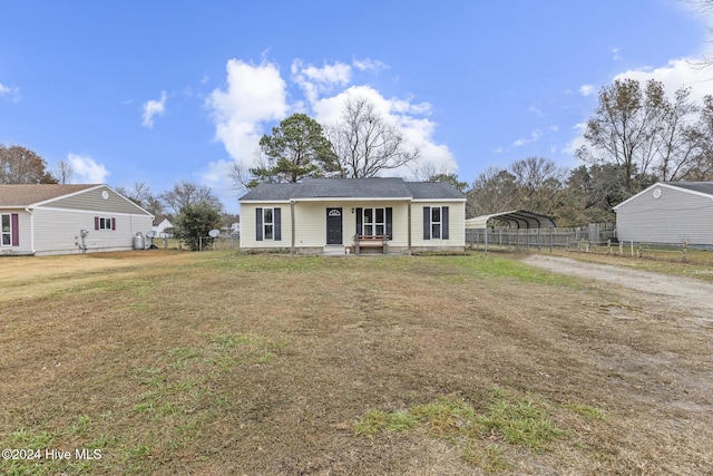 single story home featuring a front yard and a carport