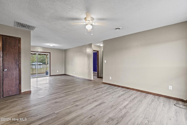 unfurnished room with ceiling fan, a textured ceiling, and light hardwood / wood-style flooring