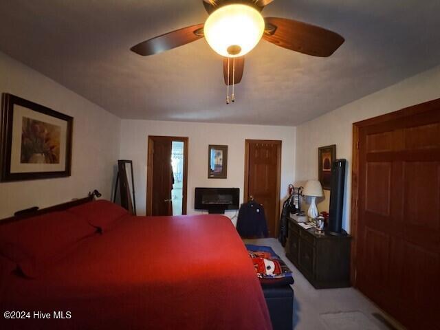 bedroom featuring ceiling fan and light colored carpet