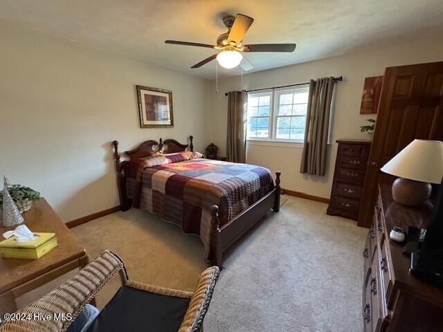 carpeted bedroom with ceiling fan