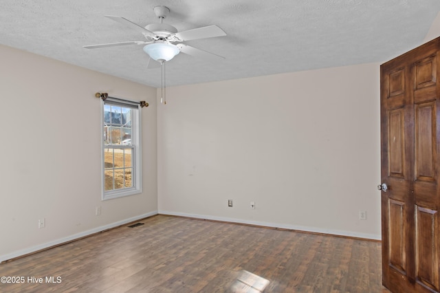 unfurnished room featuring dark hardwood / wood-style floors, ceiling fan, and a textured ceiling