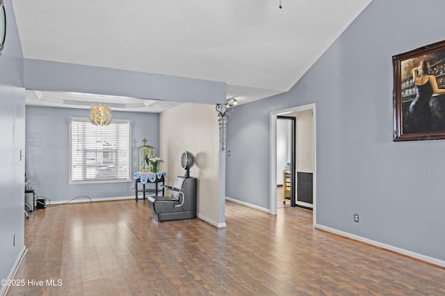 sitting room with wood-type flooring and a notable chandelier