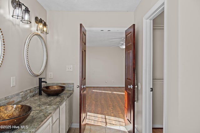 bathroom featuring ceiling fan, tile patterned flooring, and vanity