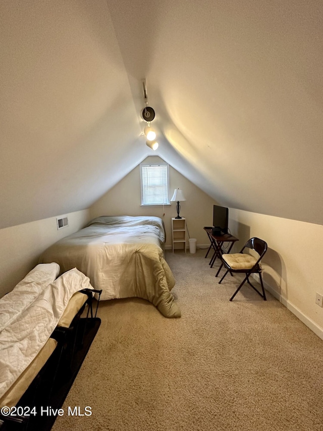 carpeted bedroom featuring vaulted ceiling