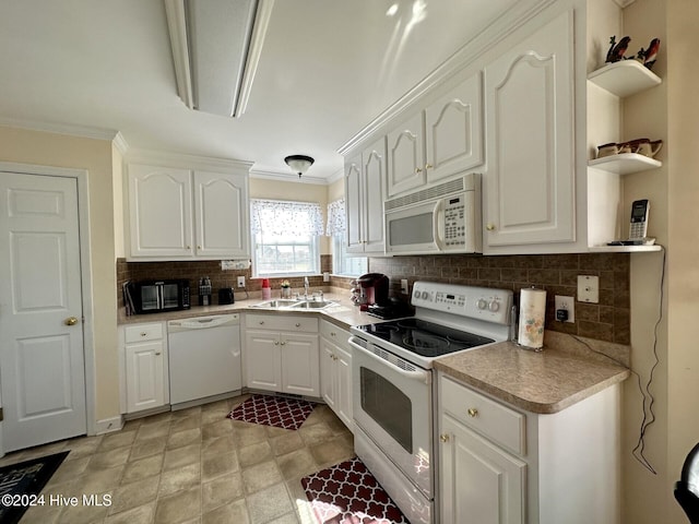 kitchen with white appliances, backsplash, crown molding, sink, and white cabinetry