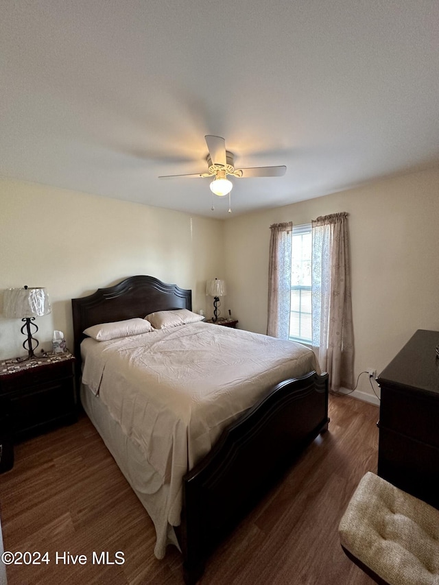 bedroom featuring ceiling fan and dark hardwood / wood-style flooring