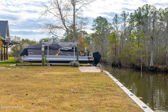 view of yard with a boat dock and a water view