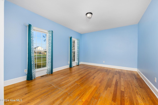 unfurnished room featuring light hardwood / wood-style flooring