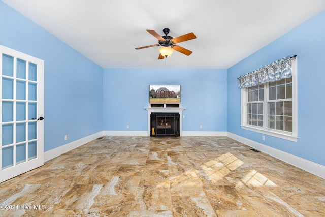 unfurnished living room with ceiling fan