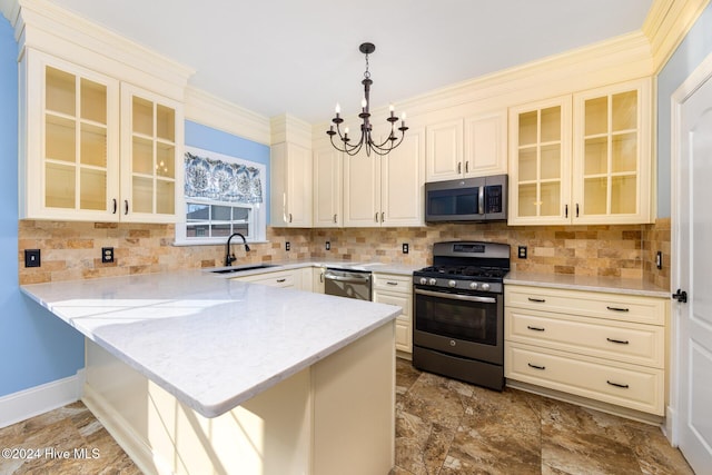 kitchen featuring decorative light fixtures, kitchen peninsula, sink, and appliances with stainless steel finishes