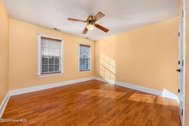 spare room featuring ceiling fan and hardwood / wood-style flooring