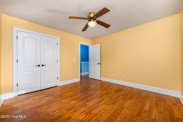 unfurnished bedroom featuring a closet, ceiling fan, and hardwood / wood-style floors