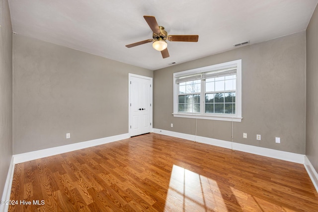 unfurnished room with ceiling fan and hardwood / wood-style floors