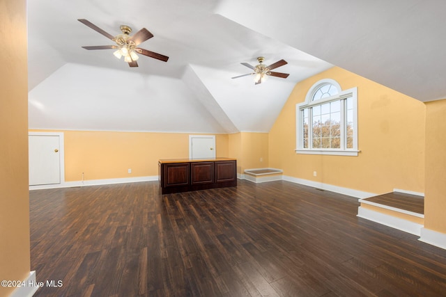 additional living space featuring dark hardwood / wood-style floors, ceiling fan, and lofted ceiling